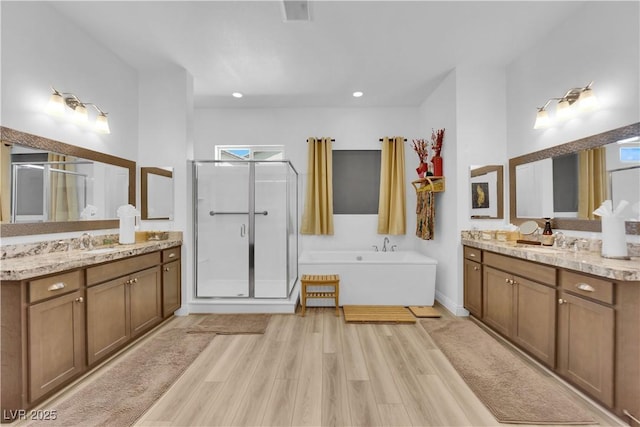 7258 W Le Baron Ave, Las Vegas, NV 89178 - full bath with a stall shower, two vanities, wood finished floors, and a tub to relax in