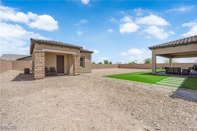 7258 W Le Baron Ave, Las Vegas, NV 89178 - rear view of property featuring stucco siding, a tiled roof, a patio area, stone siding, and a fenced backyard