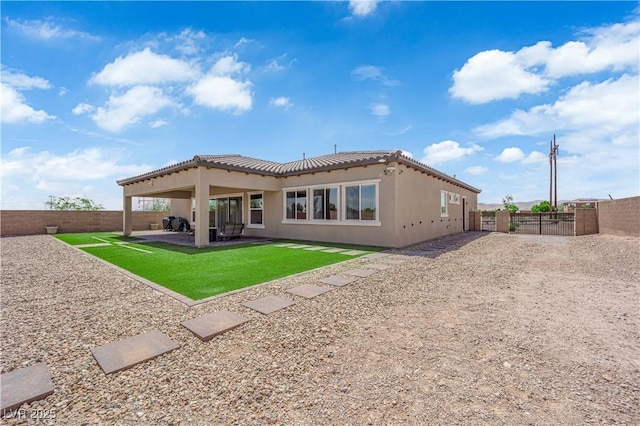 7258 W Le Baron Ave, Las Vegas, NV 89178 - rear view of house featuring stucco siding, a tiled roof, and a patio area