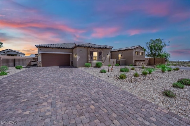 7258 W Le Baron Ave, Las Vegas, NV 89178 - mediterranean / spanish-style home with stucco siding, decorative driveway, a tile roof, and an attached garage