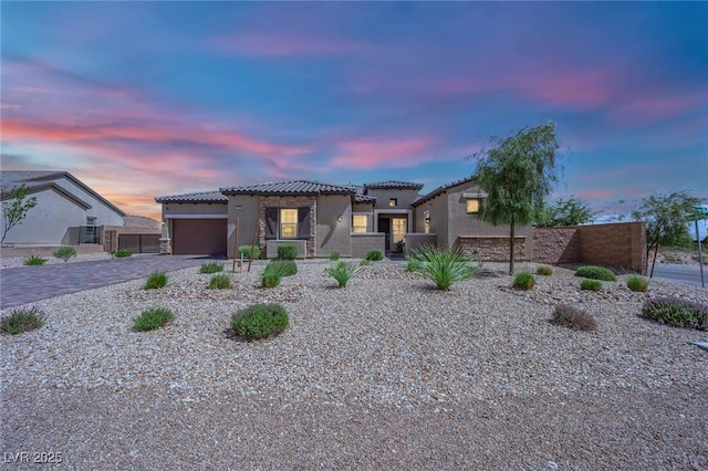 7258 W Le Baron Ave, Las Vegas, NV 89178 - mediterranean / spanish-style home with a tiled roof, stucco siding, decorative driveway, and a garage
