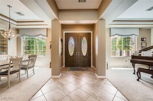 4719 Riva De Romanza St, Las Vegas, NV 89135 - entrance foyer featuring a chandelier, light colored carpet, light tile patterned floors, a raised ceiling, and ornamental molding