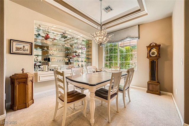 4719 Riva De Romanza St, Las Vegas, NV 89135 - dining area with ornamental molding, a raised ceiling, light carpet, a chandelier, and bar