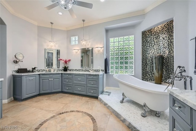 4719 Riva De Romanza St, Las Vegas, NV 89135 - bathroom with double vanity, a freestanding tub, a ceiling fan, ornamental molding, and recessed lighting