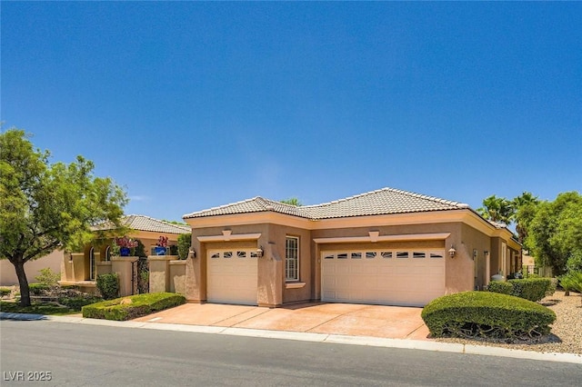 4719 Riva De Romanza St, Las Vegas, NV 89135 - view of front of house featuring a garage, a tile roof, stucco siding, and driveway