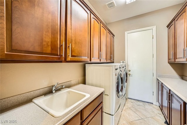 4719 Riva De Romanza St, Las Vegas, NV 89135 - laundry room with cabinet space, washer and dryer, and light tile patterned floors
