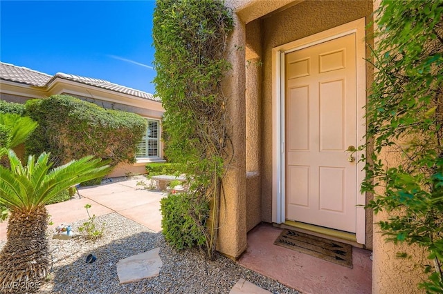 4719 Riva De Romanza St, Las Vegas, NV 89135 - view of exterior entry featuring stucco siding and a patio area