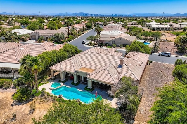 4719 Riva De Romanza St, Las Vegas, NV 89135 - aerial perspective of suburban area with a pool area and mountains