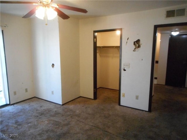 5006 Schumann Dr, Las Vegas, NV 89146 - unfurnished bedroom featuring carpet floors, a walk in closet, a closet, and ceiling fan