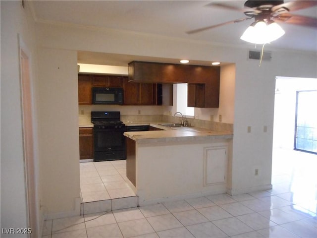 5006 Schumann Dr, Las Vegas, NV 89146 - kitchen featuring black appliances, light tile patterned flooring, light countertops, a sink, and crown molding