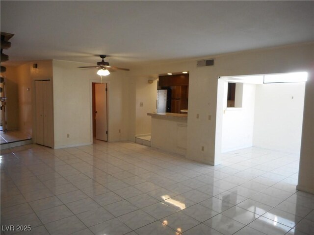 5006 Schumann Dr, Las Vegas, NV 89146 - unfurnished living room featuring light tile patterned floors and a ceiling fan