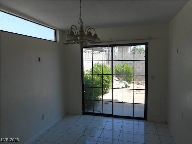 5006 Schumann Dr, Las Vegas, NV 89146 - unfurnished dining area with a chandelier, light tile patterned floors, and baseboards