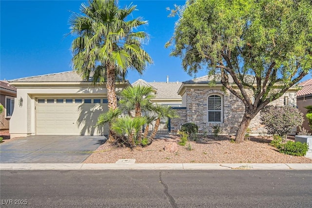 8305 Chapelle Ct, Las Vegas, NV 89131 - view of front of house featuring concrete driveway, a garage, stone siding, and stucco siding
