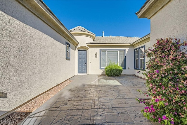 8305 Chapelle Ct, Las Vegas, NV 89131 - view of exterior entry featuring stucco siding and a patio area