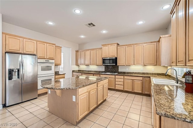 8305 Chapelle Ct, Las Vegas, NV 89131 - kitchen with stainless steel appliances, light brown cabinetry, a sink, and recessed lighting