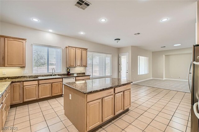 8305 Chapelle Ct, Las Vegas, NV 89131 - kitchen featuring a sink, light brown cabinets, a center island, dishwashing machine, and dark stone counters