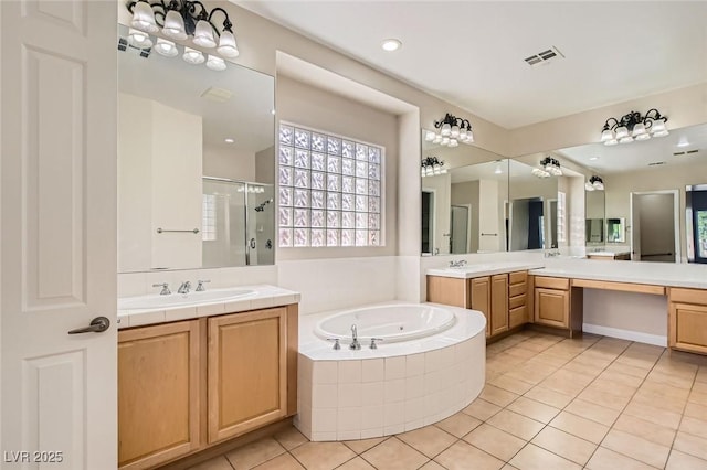 8305 Chapelle Ct, Las Vegas, NV 89131 - full bath featuring a shower stall, a garden tub, tile patterned flooring, and two vanities