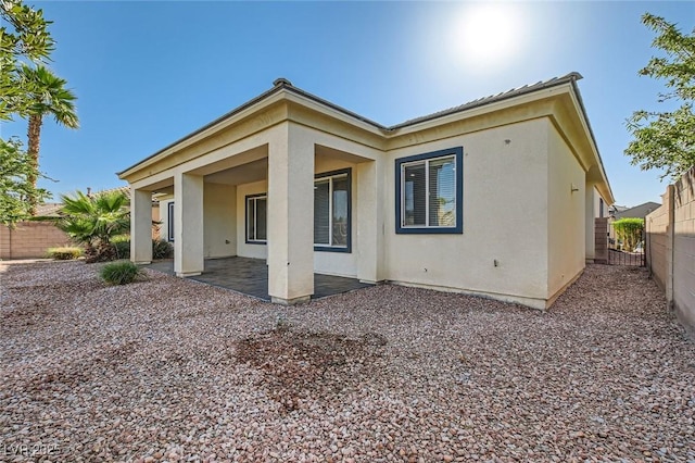 8305 Chapelle Ct, Las Vegas, NV 89131 - rear view of house featuring a patio, a fenced backyard, and stucco siding