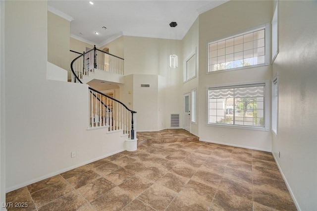 9772 Galahad Point Ct, Las Vegas, NV 89147 - entrance foyer with baseboards, stairs, crown molding, a high ceiling, and stone finish floors