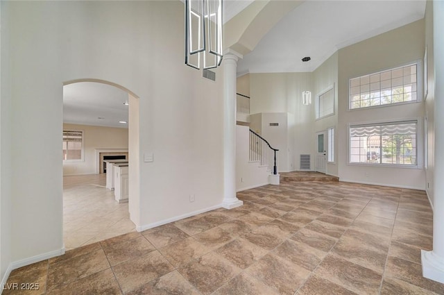 9772 Galahad Point Ct, Las Vegas, NV 89147 - foyer featuring a high ceiling, arched walkways, healthy amount of natural light, and baseboards