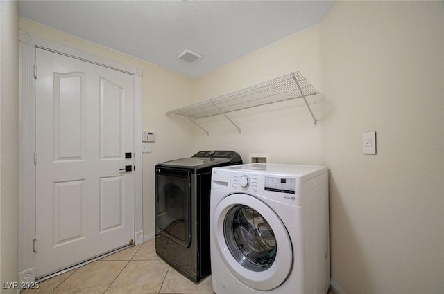 9772 Galahad Point Ct, Las Vegas, NV 89147 - laundry area with washer and dryer, light tile patterned floors, and baseboards