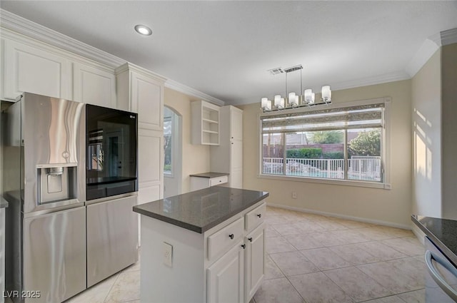 9772 Galahad Point Ct, Las Vegas, NV 89147 - kitchen with stainless steel appliances, white cabinets, a center island, crown molding, and baseboards