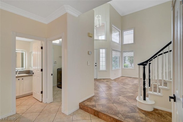 9772 Galahad Point Ct, Las Vegas, NV 89147 - foyer entrance with stairs, baseboards, ornamental molding, light tile patterned floors, and a high ceiling