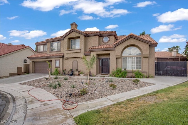 7621 Hackensack Ct, Las Vegas, NV 89128 - mediterranean / spanish-style house with a chimney, concrete driveway, stucco siding, a tiled roof, and a garage