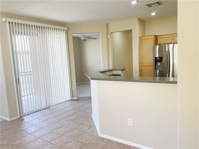 10190 Deerfield Beach Ave Unit 202, Las Vegas, NV 89129 - kitchen with stainless steel fridge, light brown cabinetry, baseboards, dark countertops, and recessed lighting