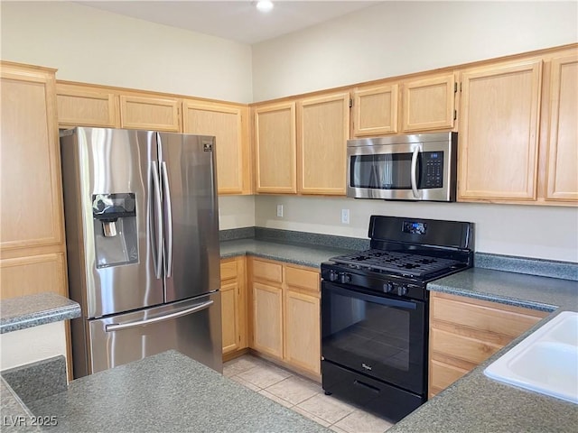 10190 Deerfield Beach Ave Unit 202, Las Vegas, NV 89129 - kitchen featuring stainless steel appliances, light brown cabinets, a sink, and dark countertops
