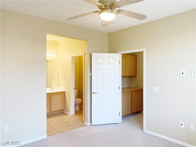 10190 Deerfield Beach Ave Unit 202, Las Vegas, NV 89129 - unfurnished bedroom with connected bathroom, light carpet, and baseboards