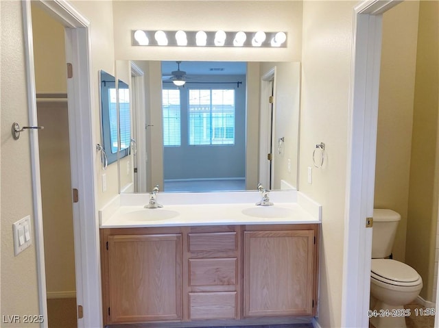 10190 Deerfield Beach Ave Unit 202, Las Vegas, NV 89129 - full bathroom with double vanity, ceiling fan, and toilet