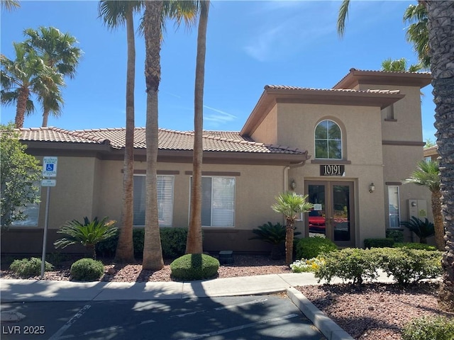 10190 Deerfield Beach Ave Unit 202, Las Vegas, NV 89129 - mediterranean / spanish house featuring stucco siding, a tiled roof, and french doors