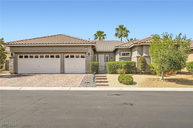 1314 Doggett Ave, Las Vegas, NV 89123 - view of front of home featuring driveway, an attached garage, stucco siding, and a tile roof