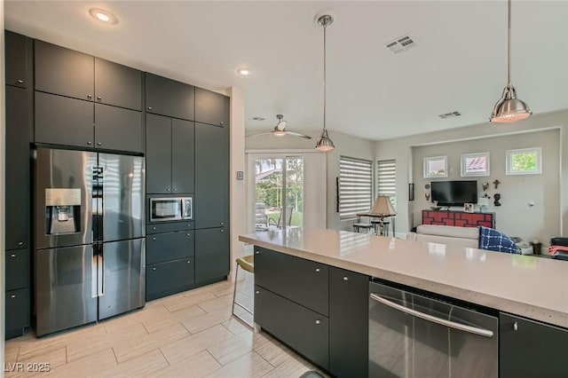 1314 Doggett Ave, Las Vegas, NV 89123 - kitchen featuring appliances with stainless steel finishes, open floor plan, light countertops, decorative light fixtures, and recessed lighting