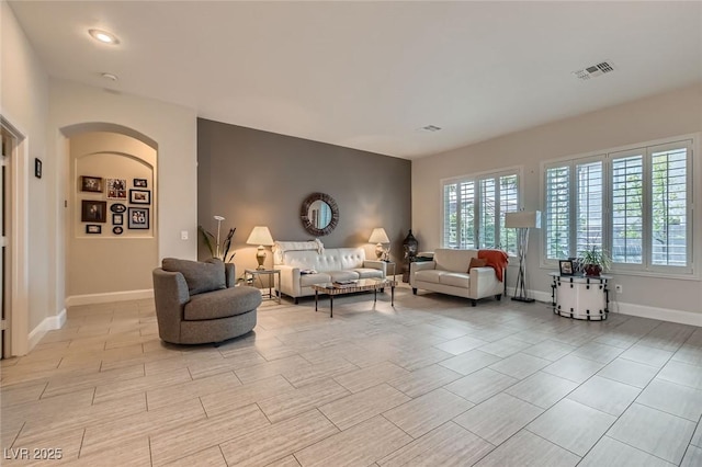 1314 Doggett Ave, Las Vegas, NV 89123 - living room featuring arched walkways and baseboards