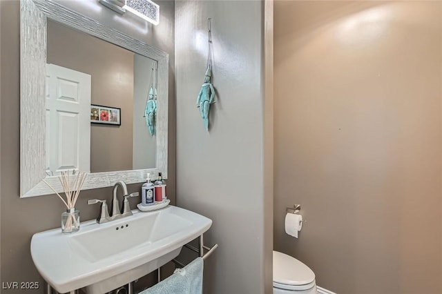 1314 Doggett Ave, Las Vegas, NV 89123 - bathroom featuring a sink, toilet, and baseboards
