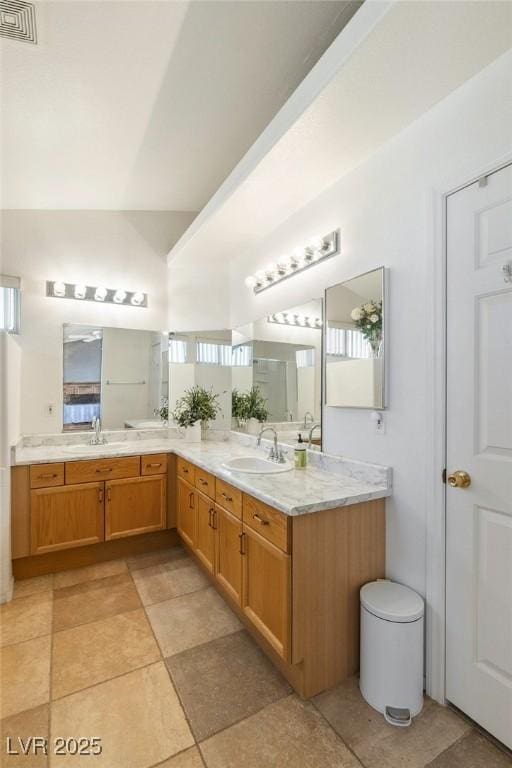 4878 Califa Dr, Las Vegas, NV 89122 - full bathroom featuring double vanity and healthy amount of natural light