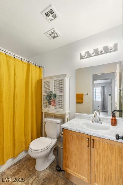4878 Califa Dr, Las Vegas, NV 89122 - full bath featuring vanity, toilet, and tile patterned floors
