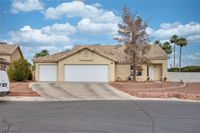 4878 Califa Dr, Las Vegas, NV 89122 - view of front facade with stucco siding, an attached garage, driveway, and a tiled roof