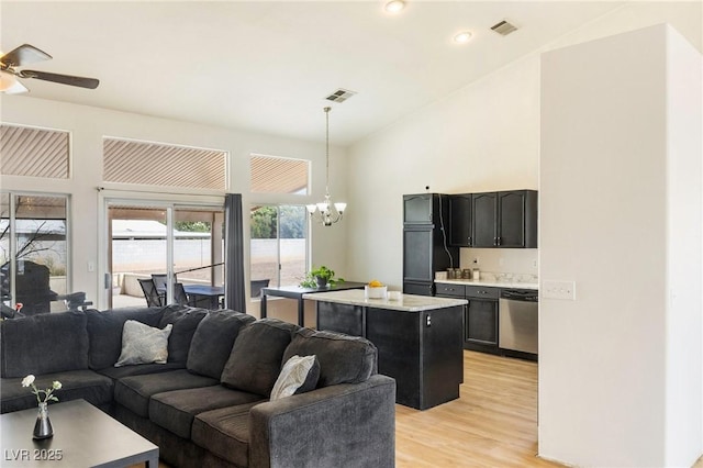 4878 Califa Dr, Las Vegas, NV 89122 - living area featuring a chandelier, light wood-type flooring, a ceiling fan, high vaulted ceiling, and recessed lighting