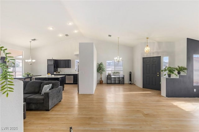 4878 Califa Dr, Las Vegas, NV 89122 - living area with a chandelier, light wood finished floors, healthy amount of natural light, and high vaulted ceiling