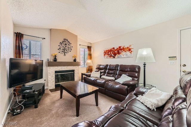 605 Devonhall St Unit 201, Las Vegas, NV 89145 - carpeted living room with vaulted ceiling, a fireplace with flush hearth, baseboards, and a textured ceiling