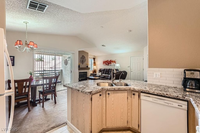 605 Devonhall St Unit 201, Las Vegas, NV 89145 - kitchen featuring white dishwasher, a sink, light brown cabinetry, a peninsula, and a chandelier