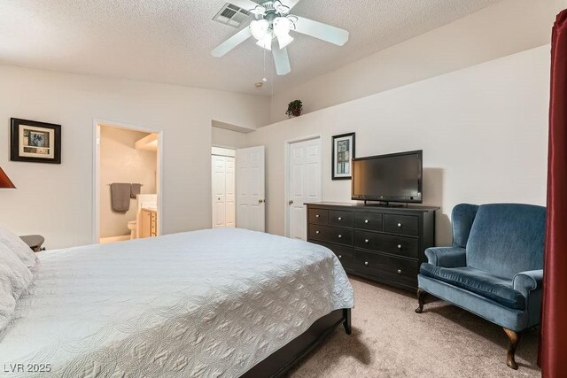 605 Devonhall St Unit 201, Las Vegas, NV 89145 - bedroom with light carpet, a textured ceiling, vaulted ceiling, ensuite bath, and ceiling fan