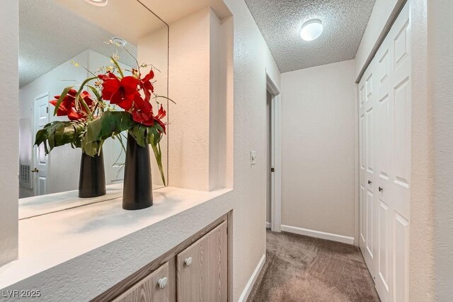 605 Devonhall St Unit 201, Las Vegas, NV 89145 - corridor featuring a textured ceiling, carpet floors, and baseboards