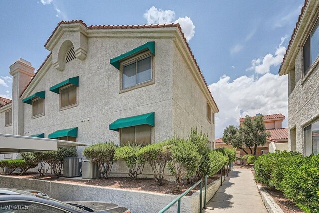 605 Devonhall St Unit 201, Las Vegas, NV 89145 - view of building exterior featuring central air condition unit