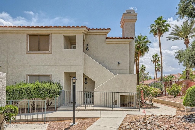 605 Devonhall St Unit 201, Las Vegas, NV 89145 - view of front facade with stucco siding and a chimney