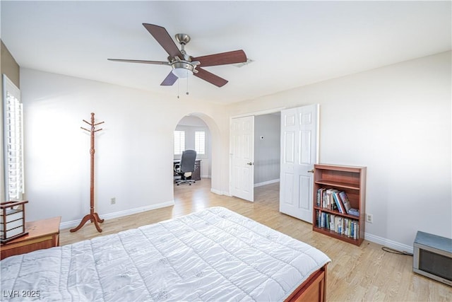 9021 Feather River Ct, Las Vegas, NV 89117 - bedroom featuring light wood finished floors, a desk, arched walkways, and a ceiling fan