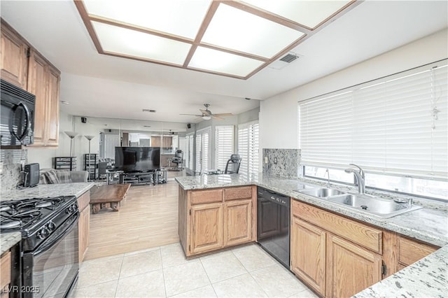 9021 Feather River Ct, Las Vegas, NV 89117 - kitchen featuring black appliances, a peninsula, a ceiling fan, and tasteful backsplash